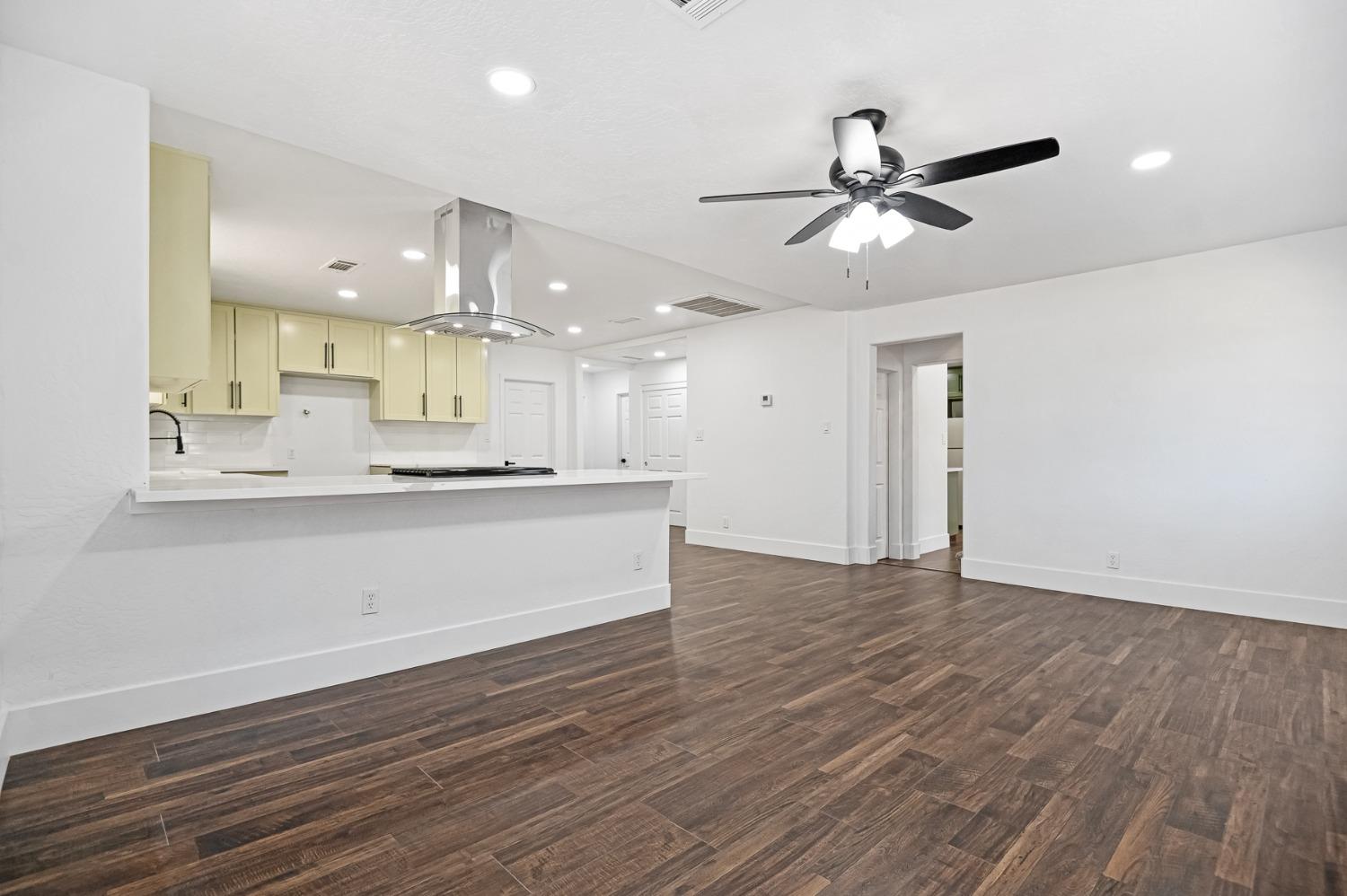 325 West Bush Street Lemoore, CA 93245 - Photo 8 of 55 a view of kitchen with wooden floor and window