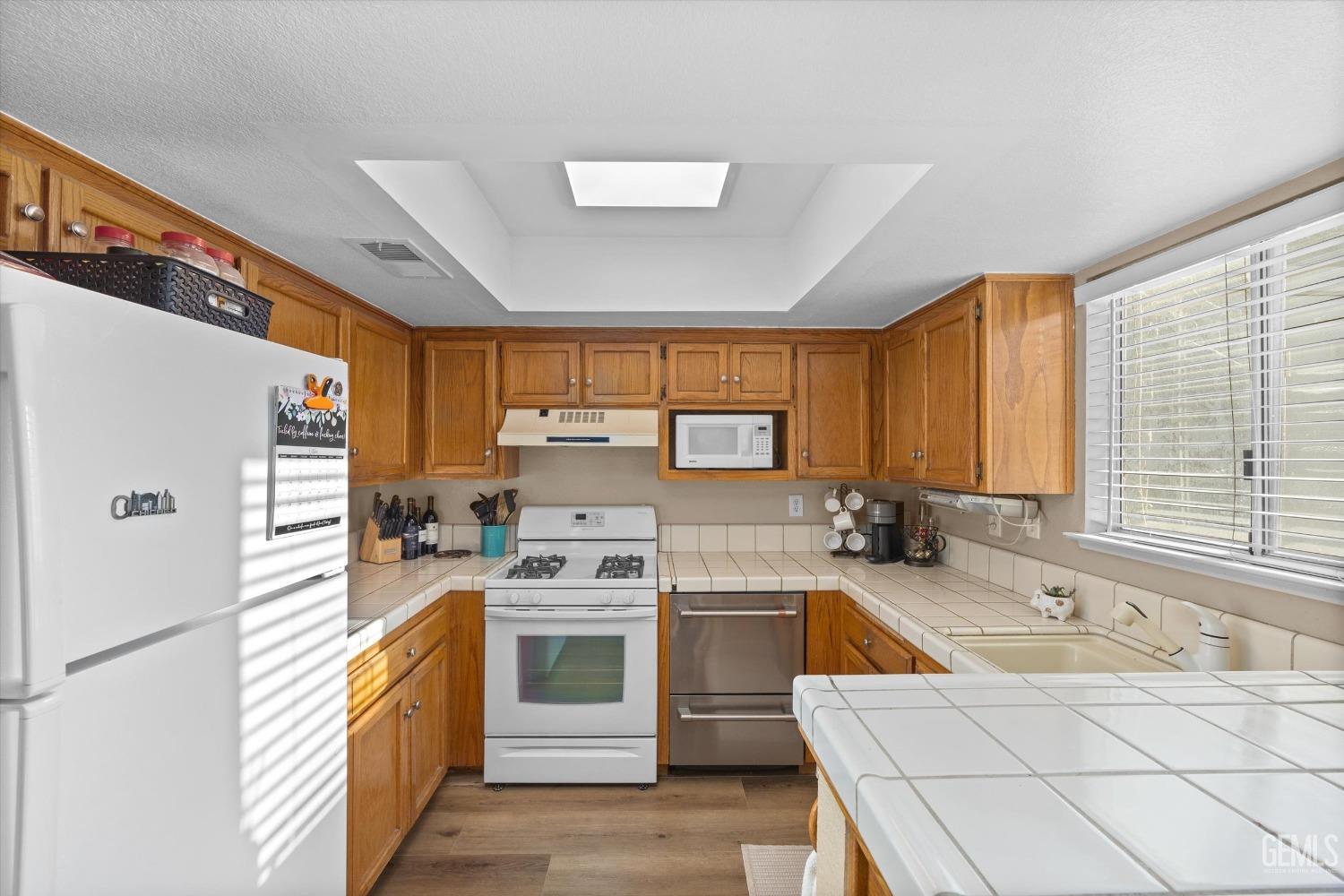 Undisclosed Address Bakersfield, CA 93311 - Photo 12 of 30 a kitchen with a sink stove and refrigerator