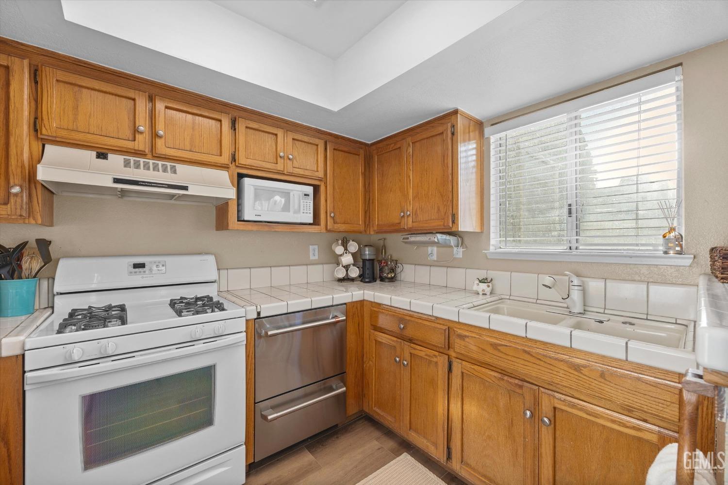 Undisclosed Address Bakersfield, CA 93311 - Photo 13 of 30 a kitchen with cabinets appliances a sink and a window