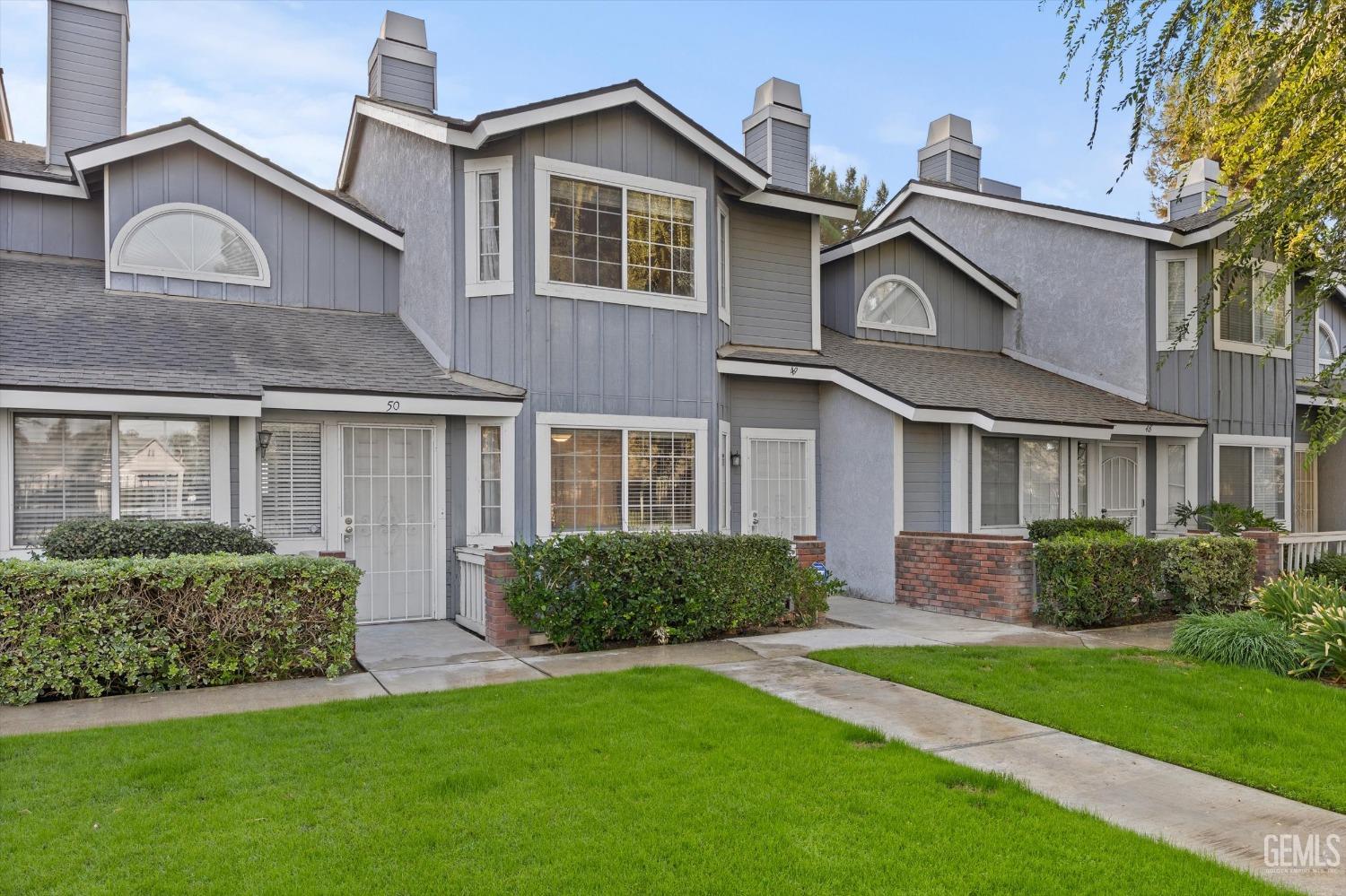 Undisclosed Address Bakersfield, CA 93311 - Photo 2 of 30 a front view of a house with a garden