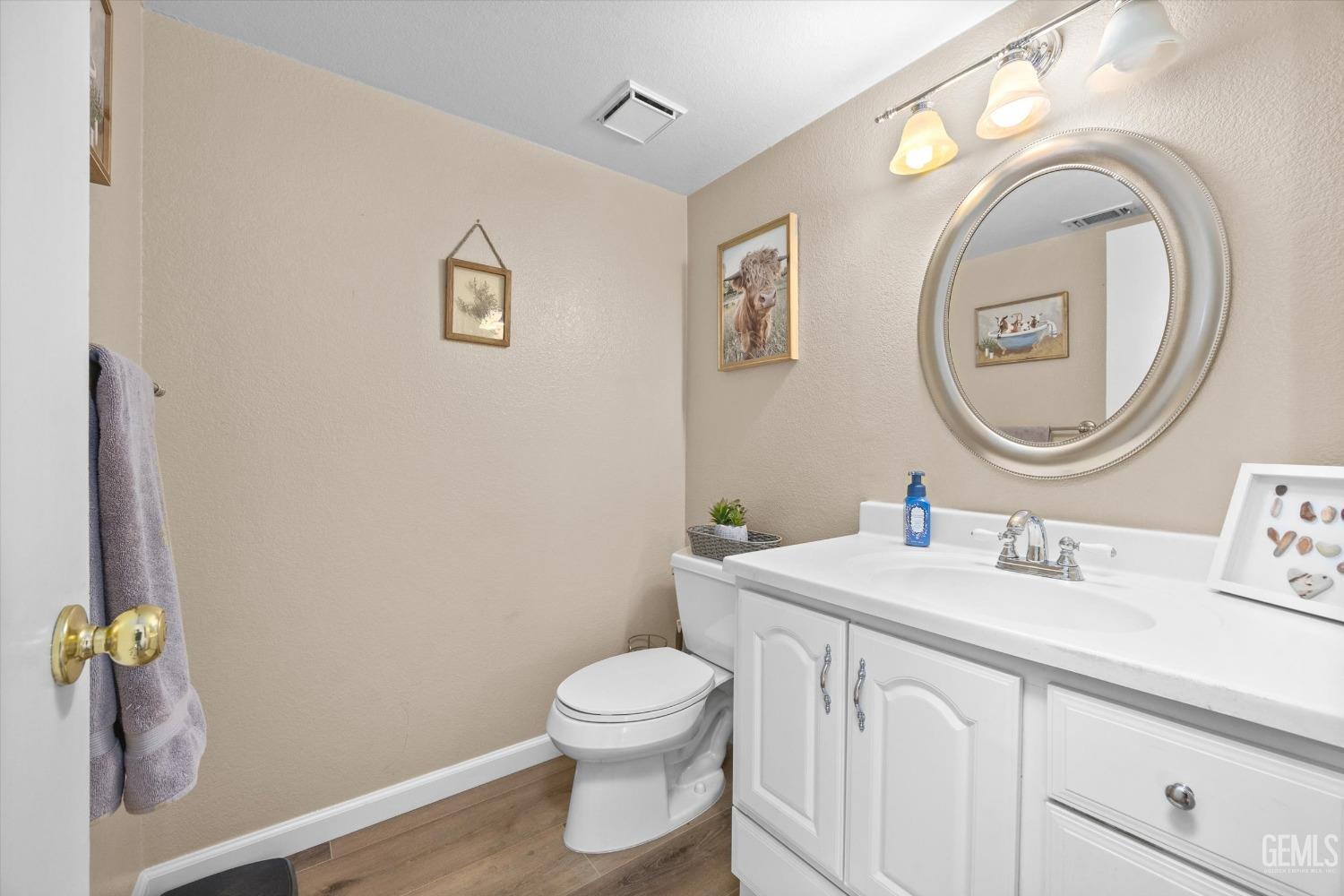 Undisclosed Address Bakersfield, CA 93311 - Photo 10 of 30 a bathroom with a toilet a sink and mirror