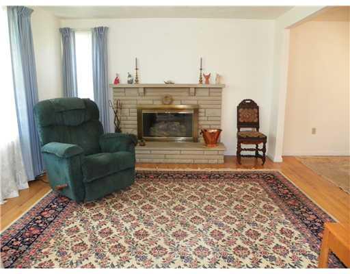 47 Dover Road Irwin, PA 15642 - Photo 3 of 18 Living Room. The living room features a stone brick fireplace at one end.