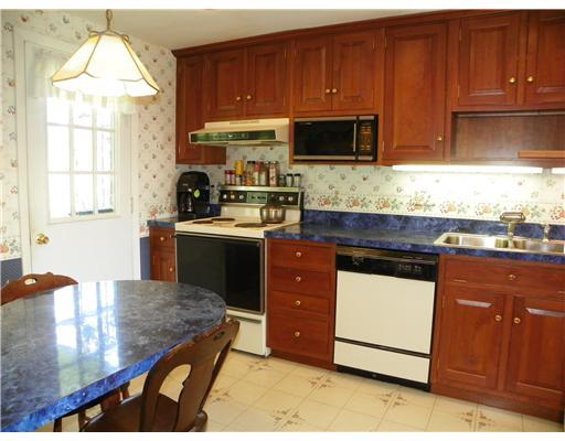 47 Dover Road Irwin, PA 15642 - Photo 6 of 18 Kitchen. Beautiful Cherry cabinets gleam in the custom kitchen, that includes dishwasher, electric stove, refrigerator, and microwave oven.