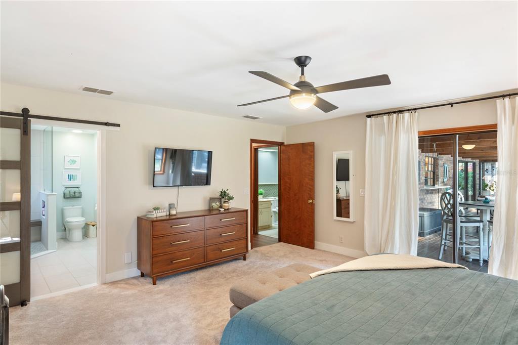 2941 Chelsea Woods Drive Valrico, FL 33596 - Photo 19 of 48 a spacious bedroom with a bed and a chandelier