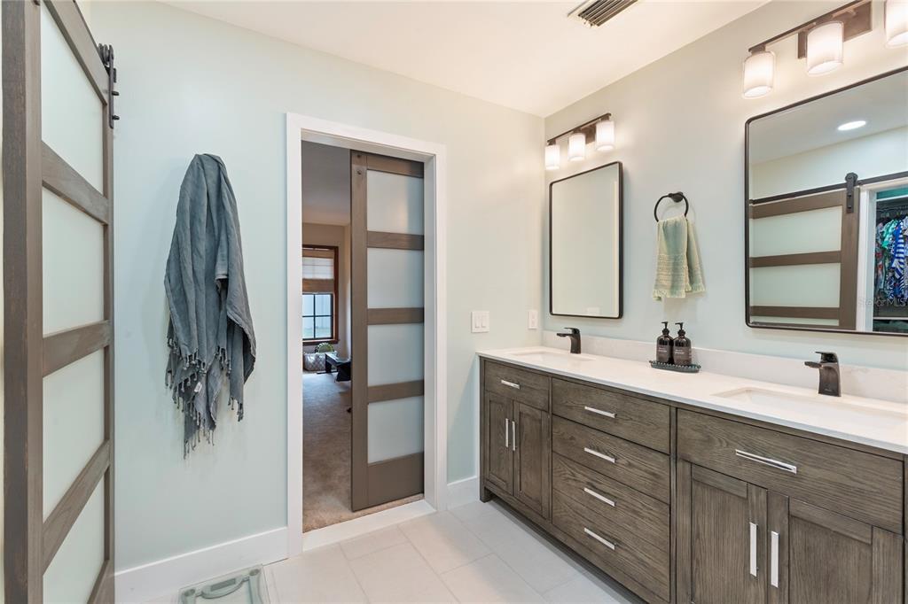 2941 Chelsea Woods Drive Valrico, FL 33596 - Photo 21 of 48 a bathroom with a double vanity sink and mirror