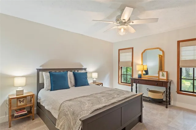 a bedroom with a large bed and a chandelier