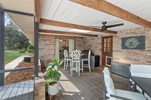 a patio with yard glass top table and chairs