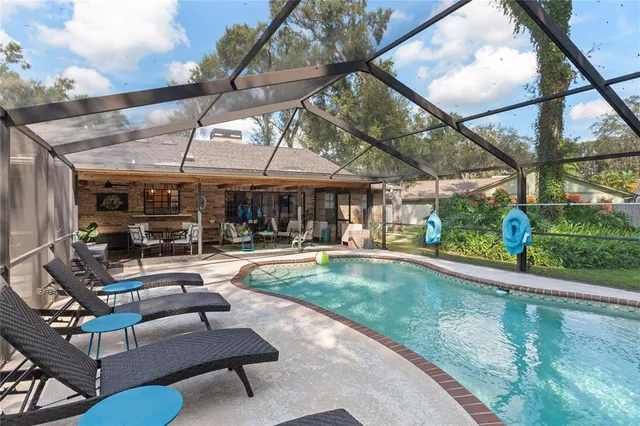 a view of a backyard with table and chairs under an umbrella