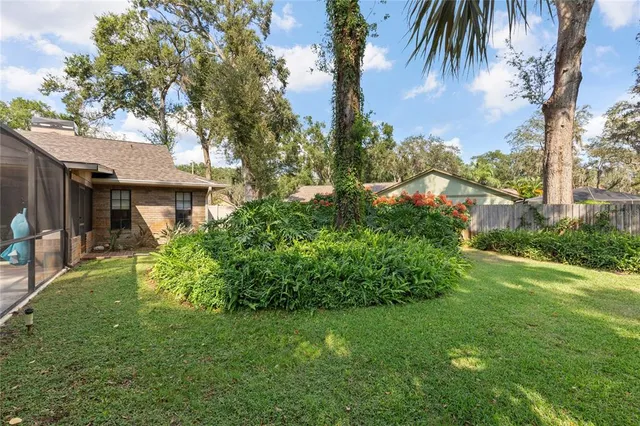 a view of a house with a yard and sitting area