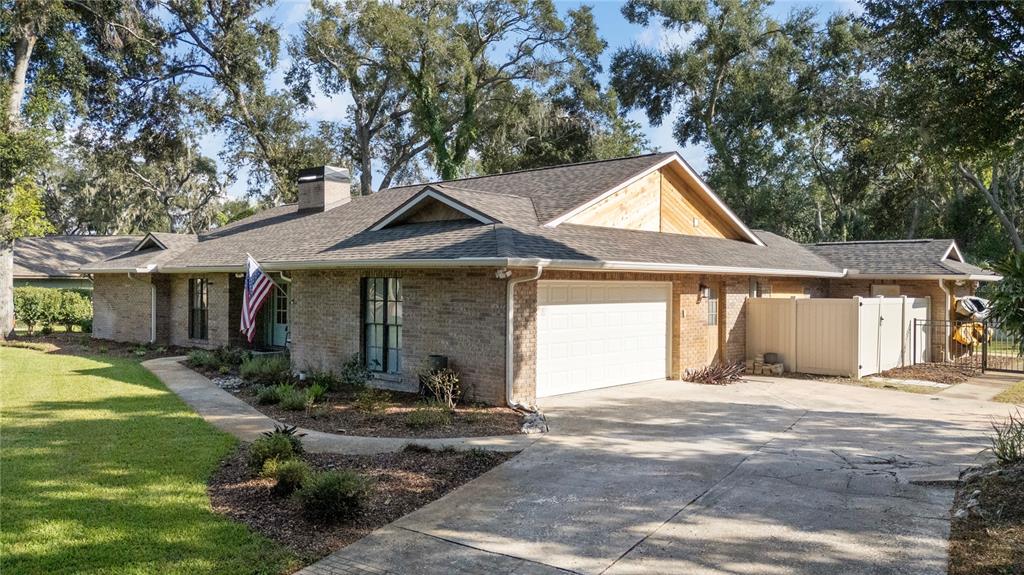 2941 Chelsea Woods Drive Valrico, FL 33596 - Photo 44 of 48 a front view of a house with a yard and garage