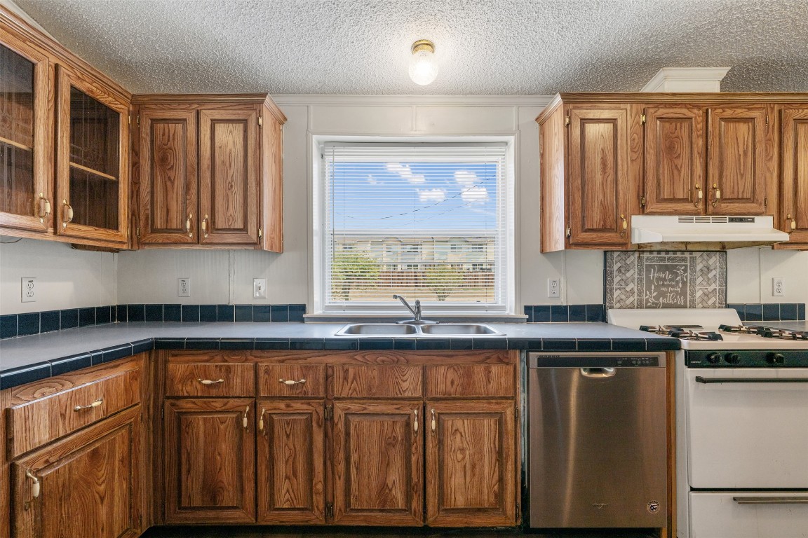 635 West Dittmar Road Austin, TX 78748 - Photo 11 of 32 a kitchen with granite countertop wooden cabinets and a window