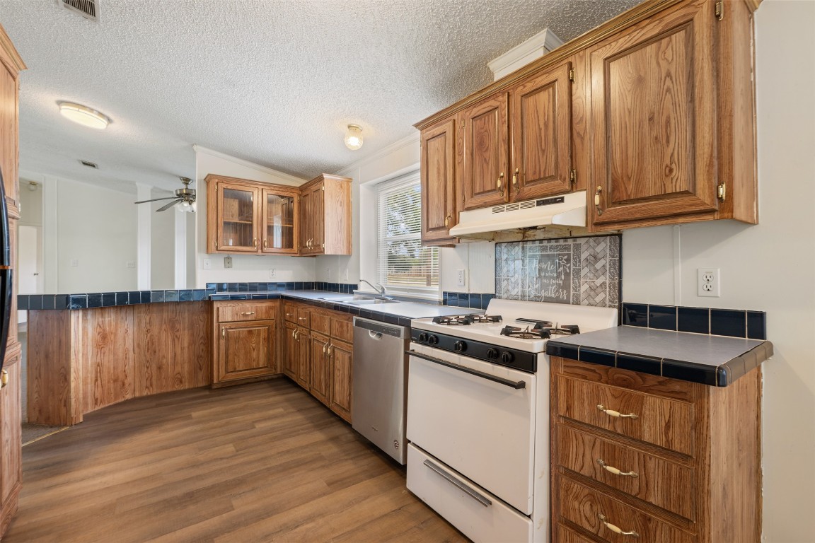 635 West Dittmar Road Austin, TX 78748 - Photo 12 of 32 a kitchen with stainless steel appliances granite countertop a stove a sink and a microwave