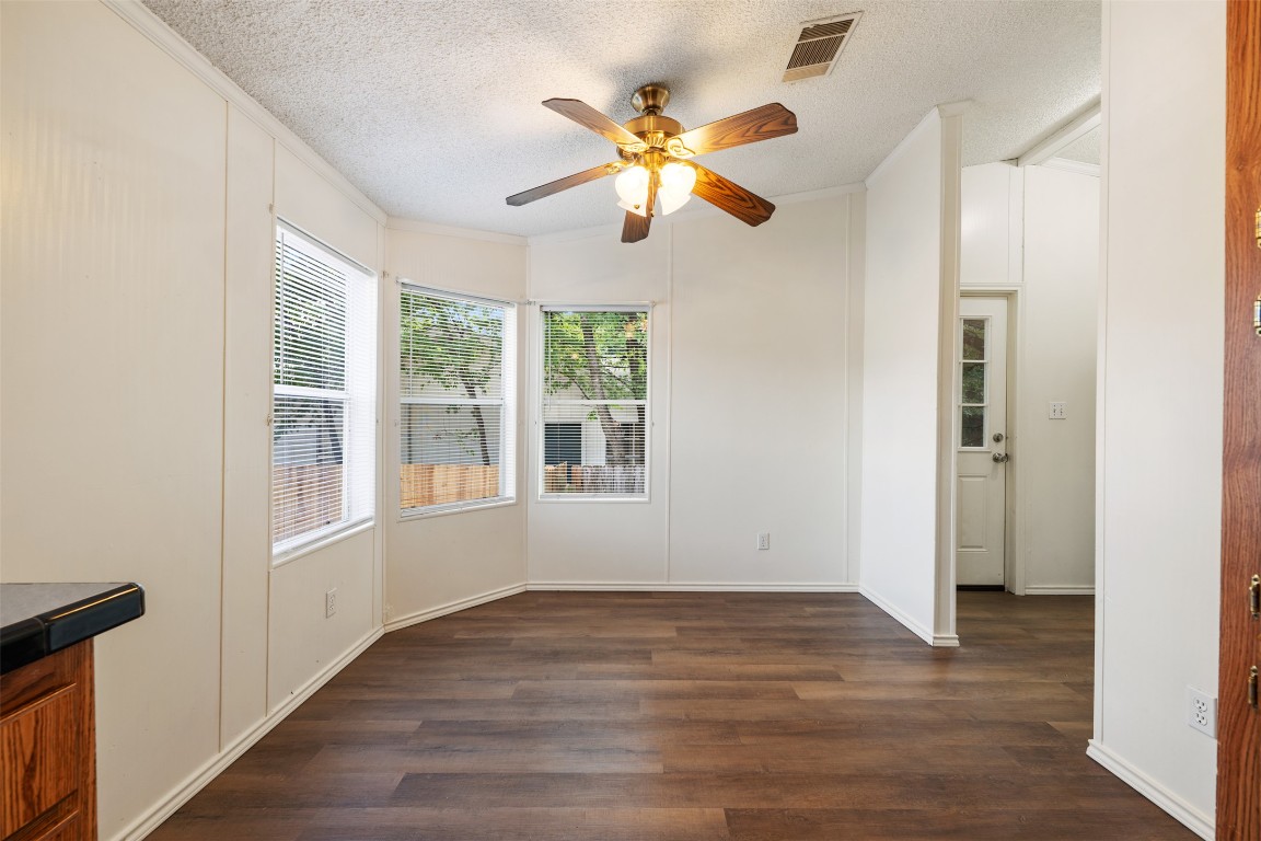 635 West Dittmar Road Austin, TX 78748 - Photo 15 of 32 an empty room with wooden floor fan and windows