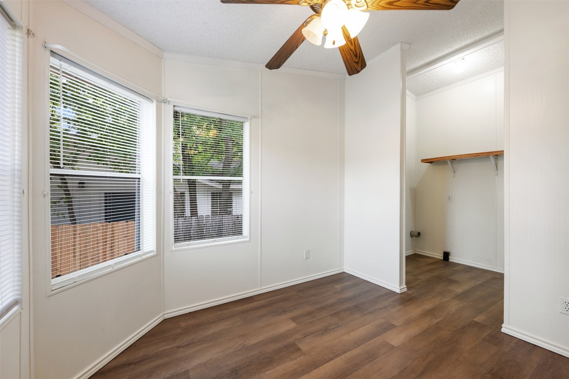 635 West Dittmar Road Austin, TX 78748 - Photo 16 of 32 an empty room with wooden floor cabinet and windows