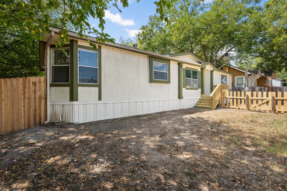 635 West Dittmar Road Austin, TX 78748 - Photo 3 of 32 a view of a backyard with large trees and wooden fence