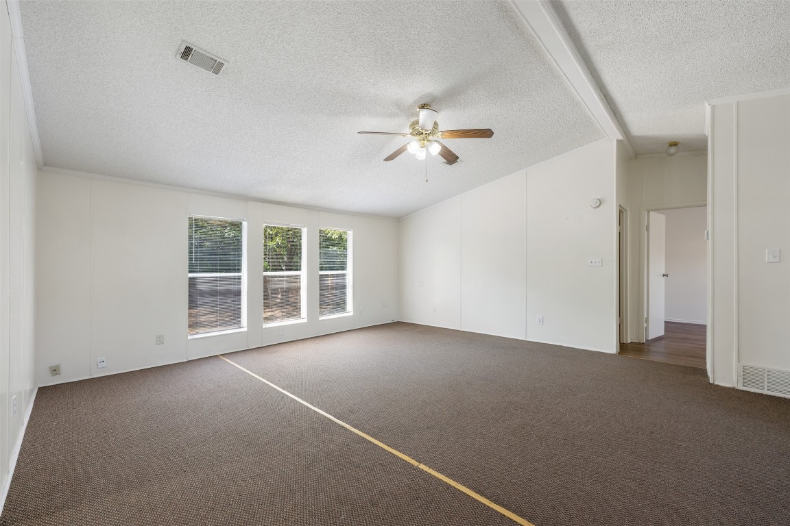 635 West Dittmar Road Austin, TX 78748 - Photo 8 of 32 an empty room with windows and chandelier fan