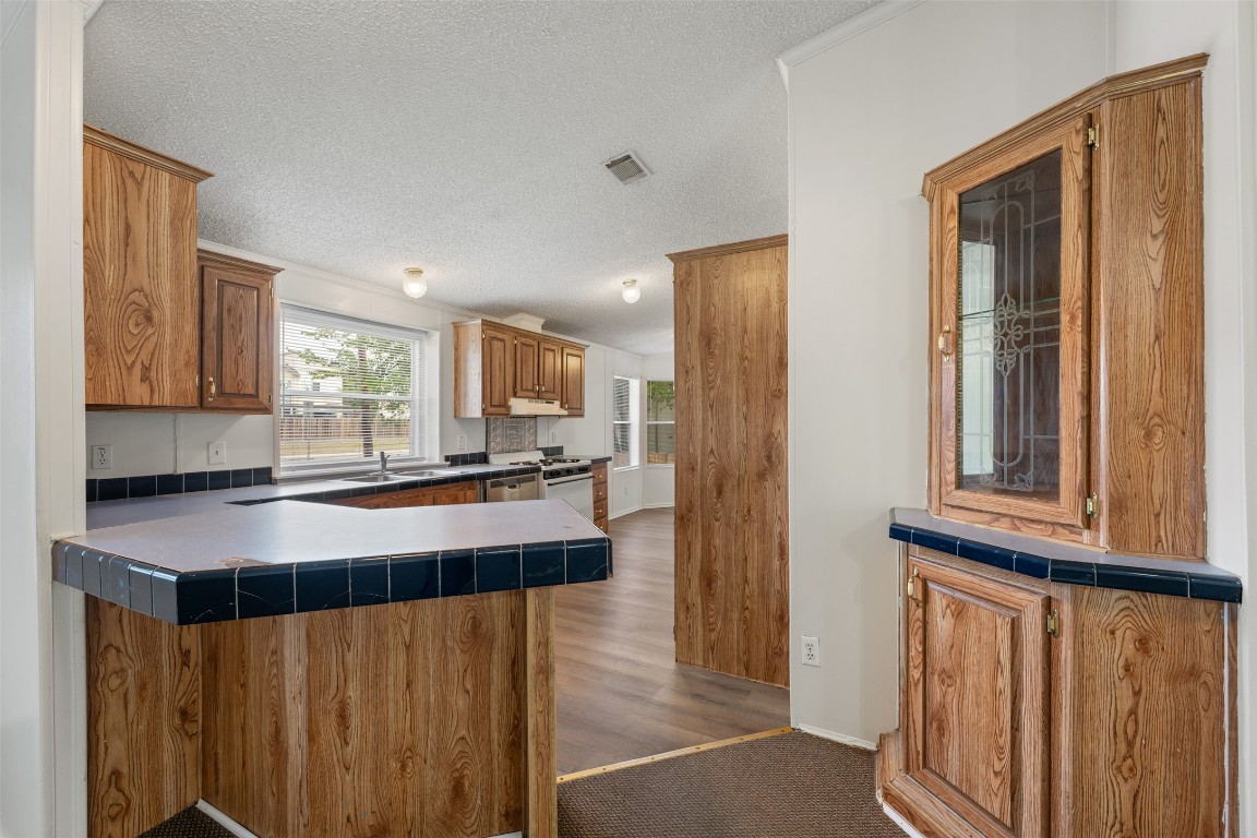 635 West Dittmar Road Austin, TX 78748 - Photo 9 of 32 a kitchen with a refrigerator and a counter top space