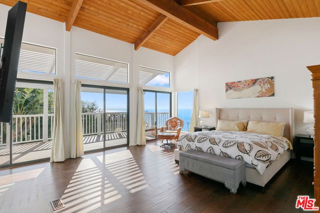 a bedroom with a bed and a large window