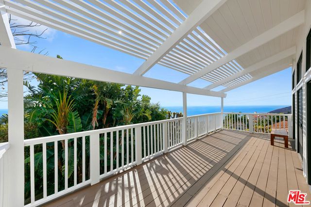 a view of balcony with wooden floor