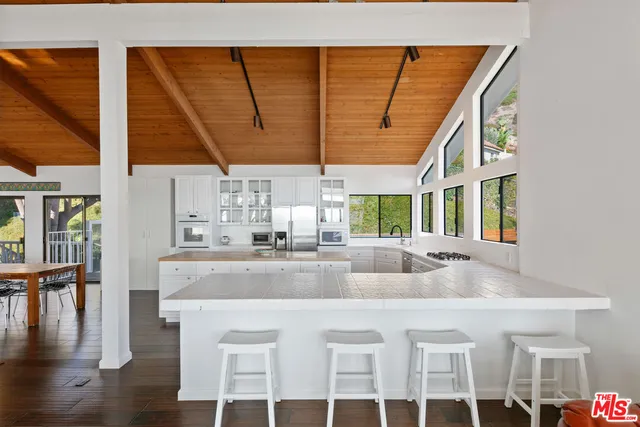 a kitchen with a sink and wooden floor