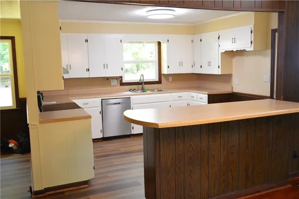 a kitchen with a sink a stove and cabinets