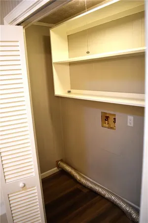 a view of a bathroom with wooden floor and a window