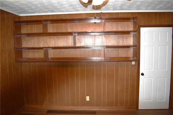 a room with a window and a ceiling fan