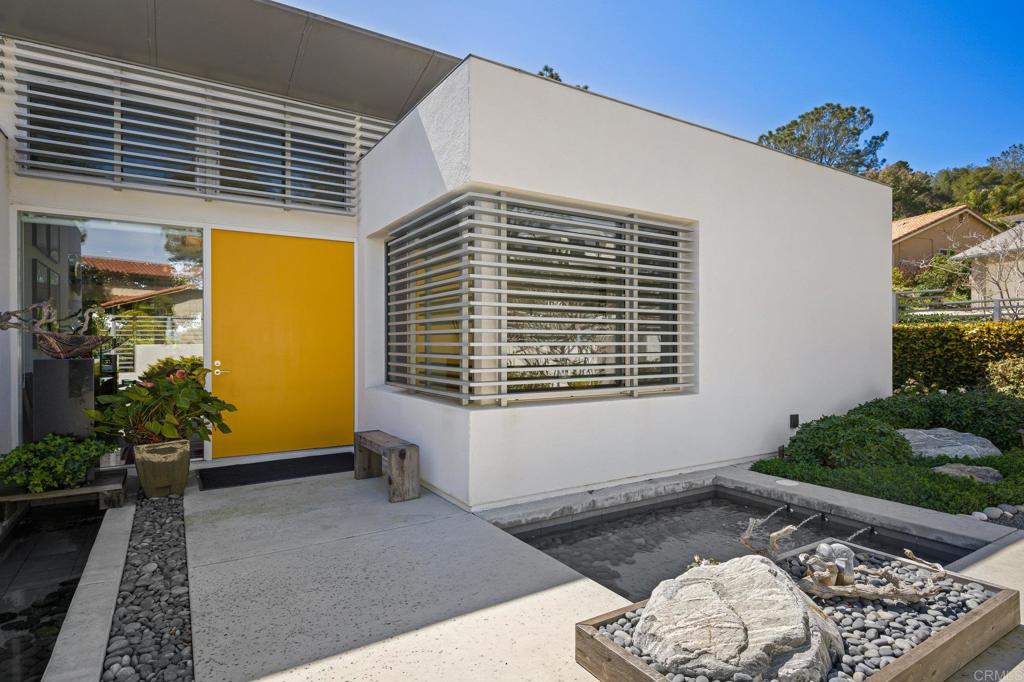 13260 Mango Drive Del Mar, CA 92014 - Photo 4 of 46 a view of a porch with a table and chairs and potted plants