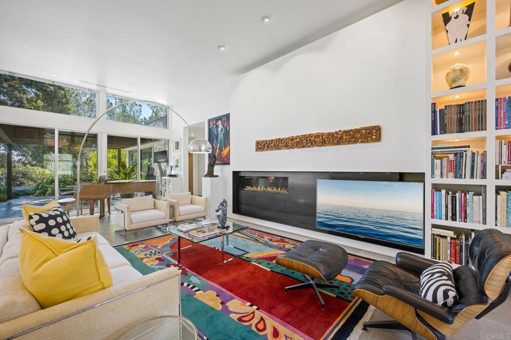13260 Mango Drive Del Mar, CA 92014 - Photo 8 of 46 a living room with furniture tv and a large window