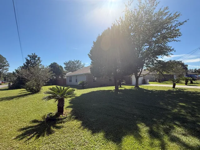 a house with green field in front of it