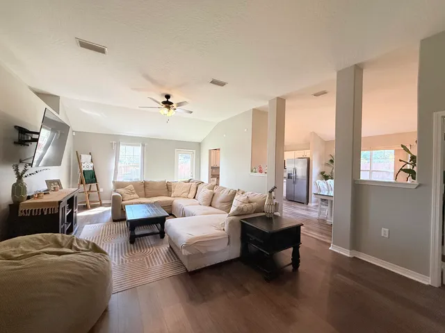 a spacious bedroom with a bed and a chandelier