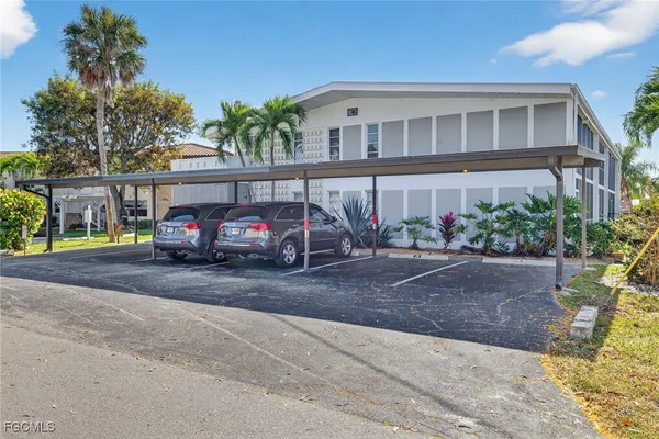 a car parked in front of a white house