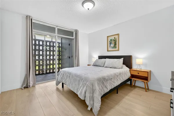 a bedroom with a bed and a painting on the wall