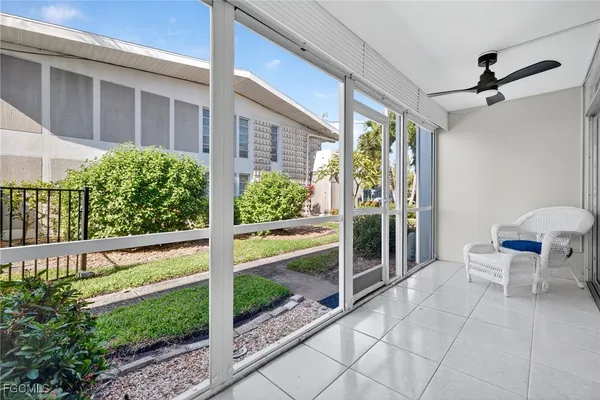 a view of a balcony with chair and table