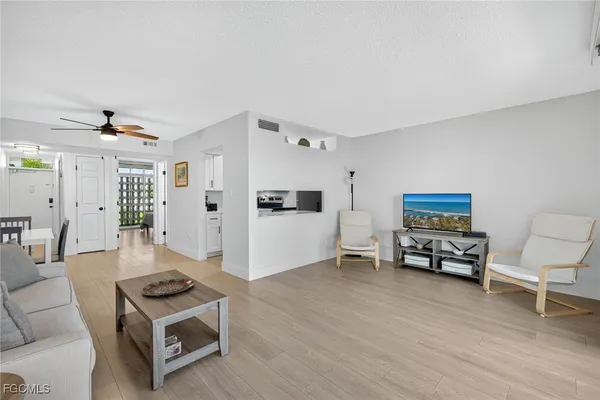 a living room with furniture and a wooden floor