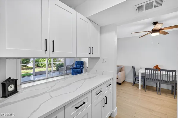 a kitchen with a refrigerator sink and cabinets
