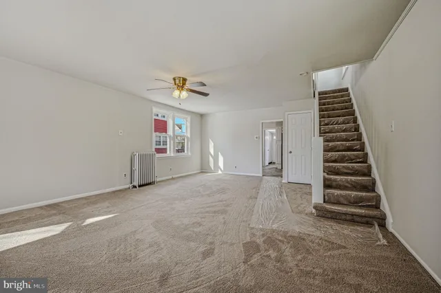 a view of an empty room with stairs