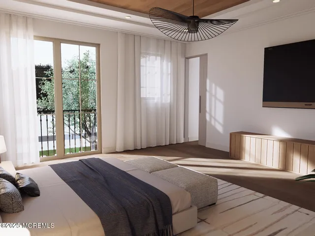 a bedroom with a large bed and a flat tv screen on dresser