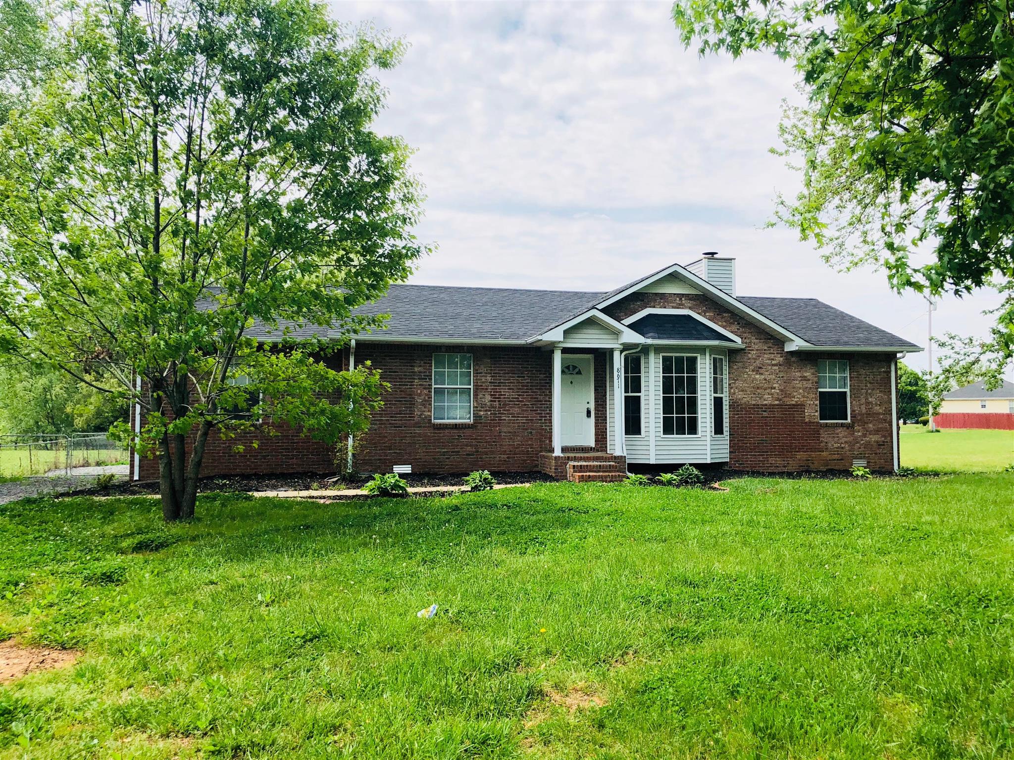 8671 Pembroke Oak Grove Road Oak Grove, KY 42262 - Photo 1 of 11 a front view of a house with a garden