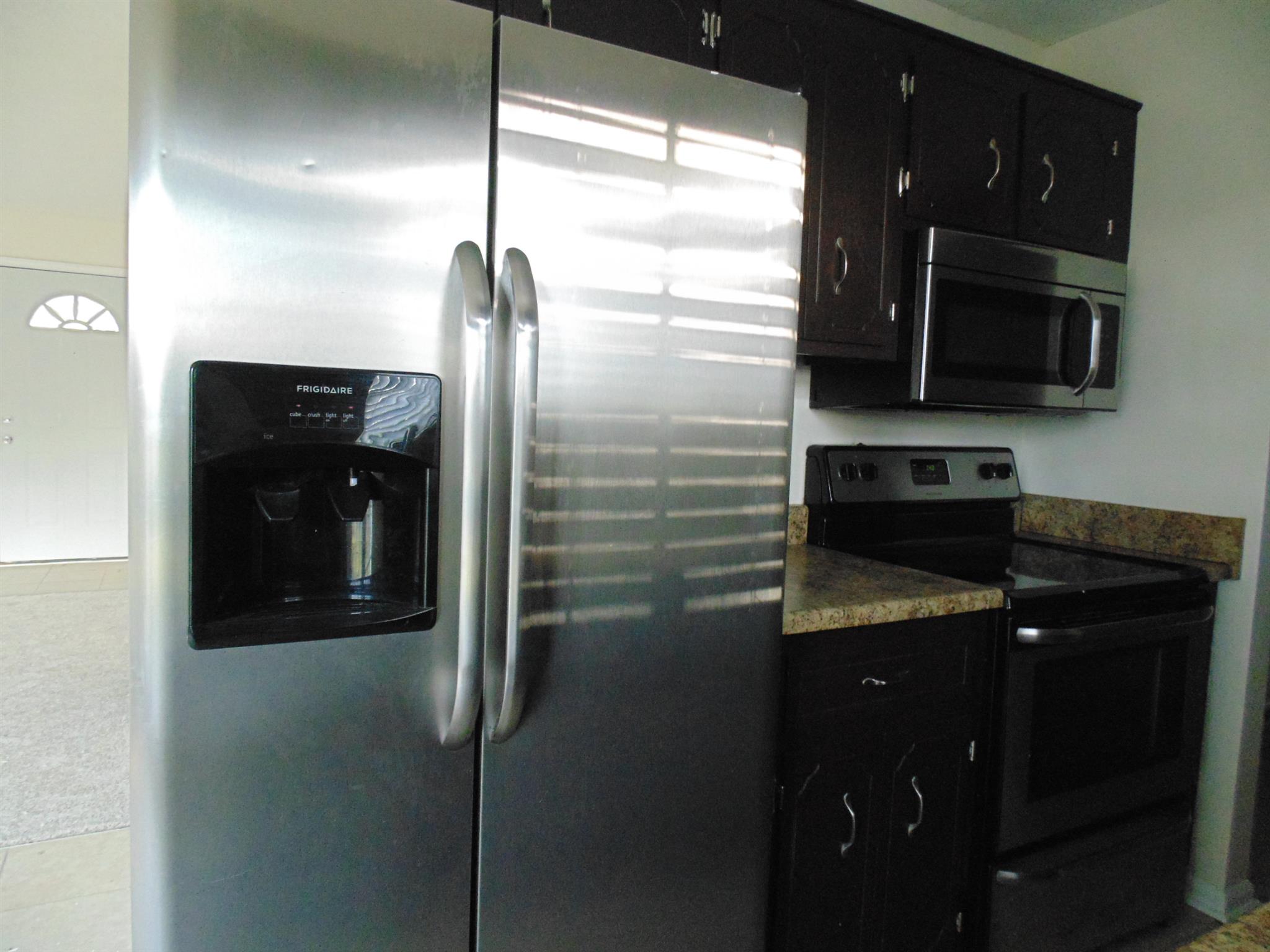 8671 Pembroke Oak Grove Road Oak Grove, KY 42262 - Photo 3 of 11 a kitchen with a refrigerator and a microwave