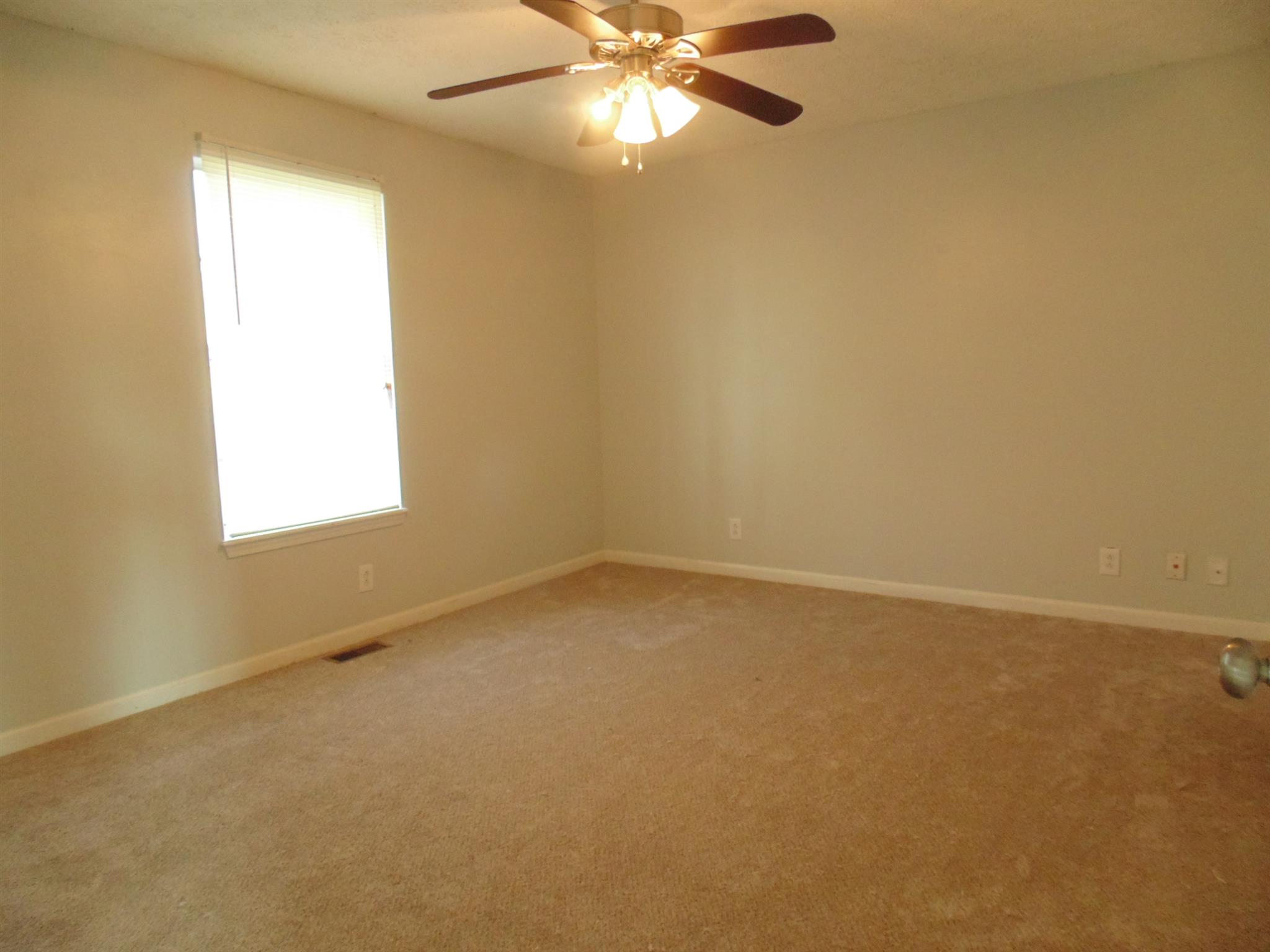 8671 Pembroke Oak Grove Road Oak Grove, KY 42262 - Photo 6 of 11 an empty room with a window and a fan