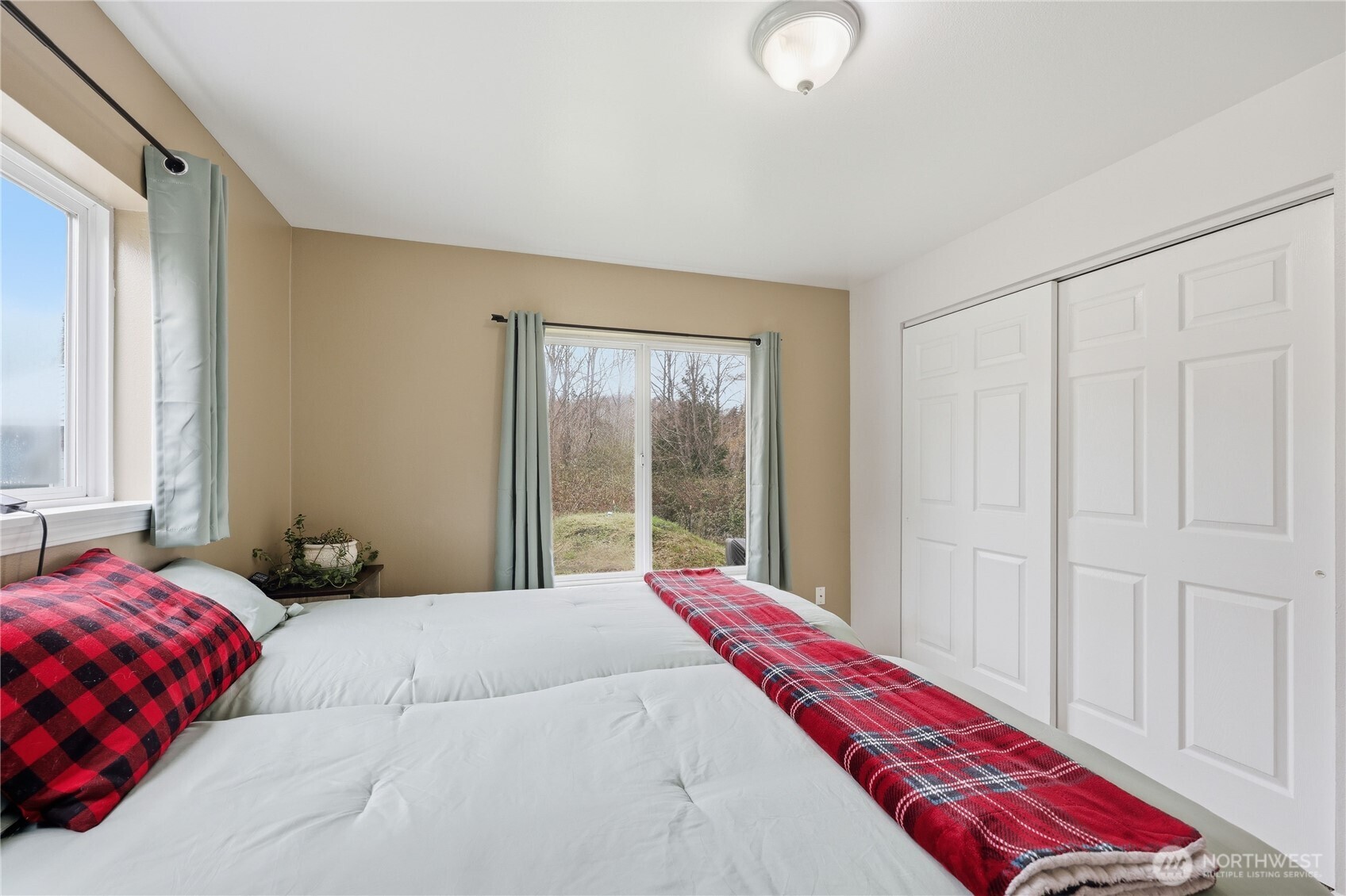 331 Bachelor Road Sequim, WA 98382 - Photo 16 of 36 a bedroom with a bed and a window