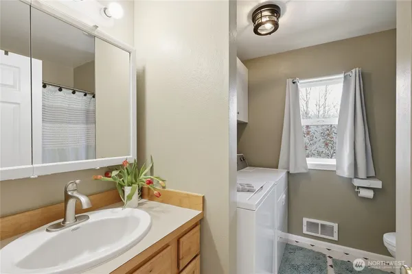 a bathroom with a sink double vanity and a mirror