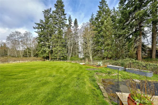 a view of a house with a yard and sitting area