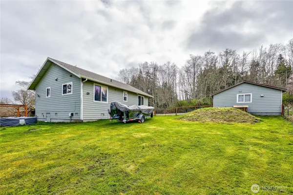 a view of a back yard of the house with a yard