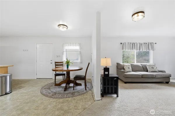 a living room with furniture a rug and a window