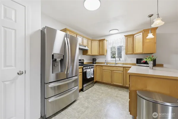 a kitchen with a refrigerator sink and microwave