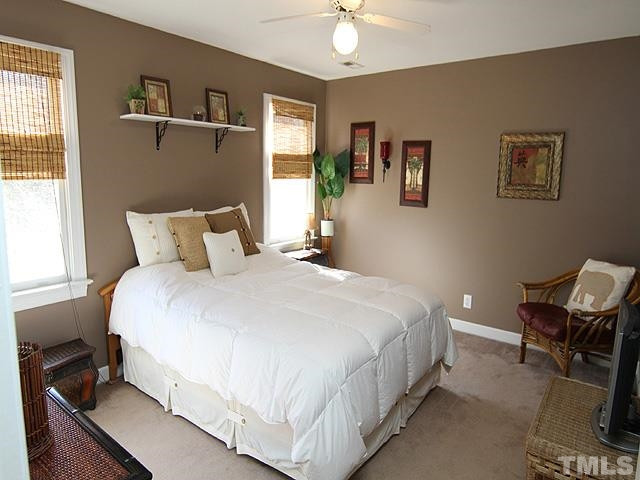 11800 Pembridge Lane Raleigh, NC 27613 - Photo 13 of 25 Large bedroom with walk-in closet, ceiling fan and with view of front yard.