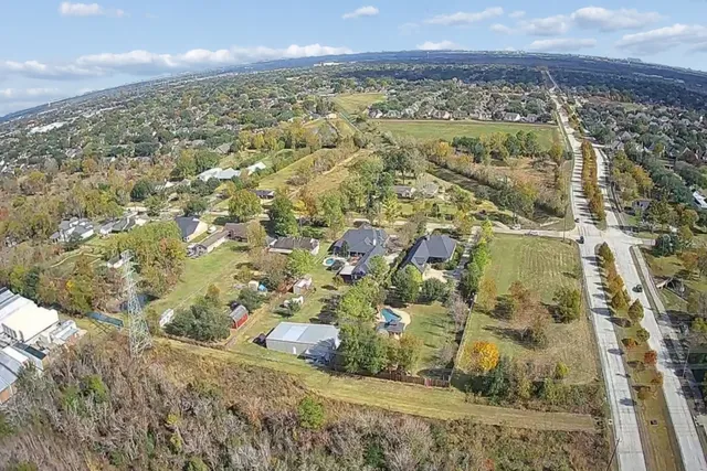 an aerial view of residential houses with outdoor space
