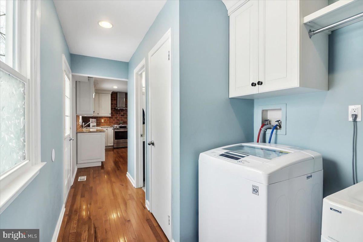 11 North Williamson Road Avondale, PA 19311 - Photo 23 of 36 a view of washer and dryer with kitchen in the background